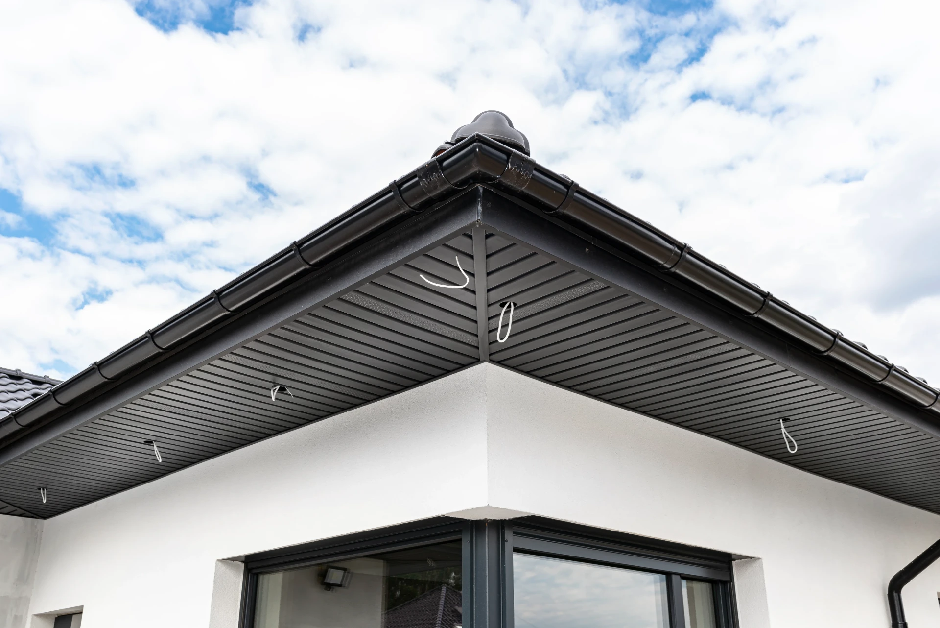 Ventilated soffit and gutter corner detail on a replacement roofline
